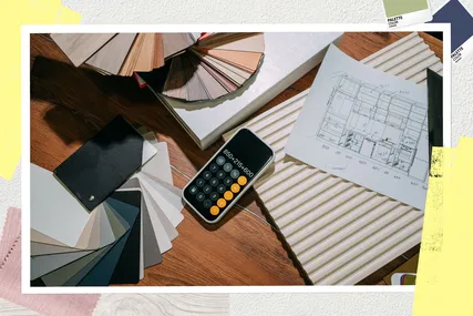 A collection of materials calculator and a floor plan on a wooden surface representing a design or renovation project context